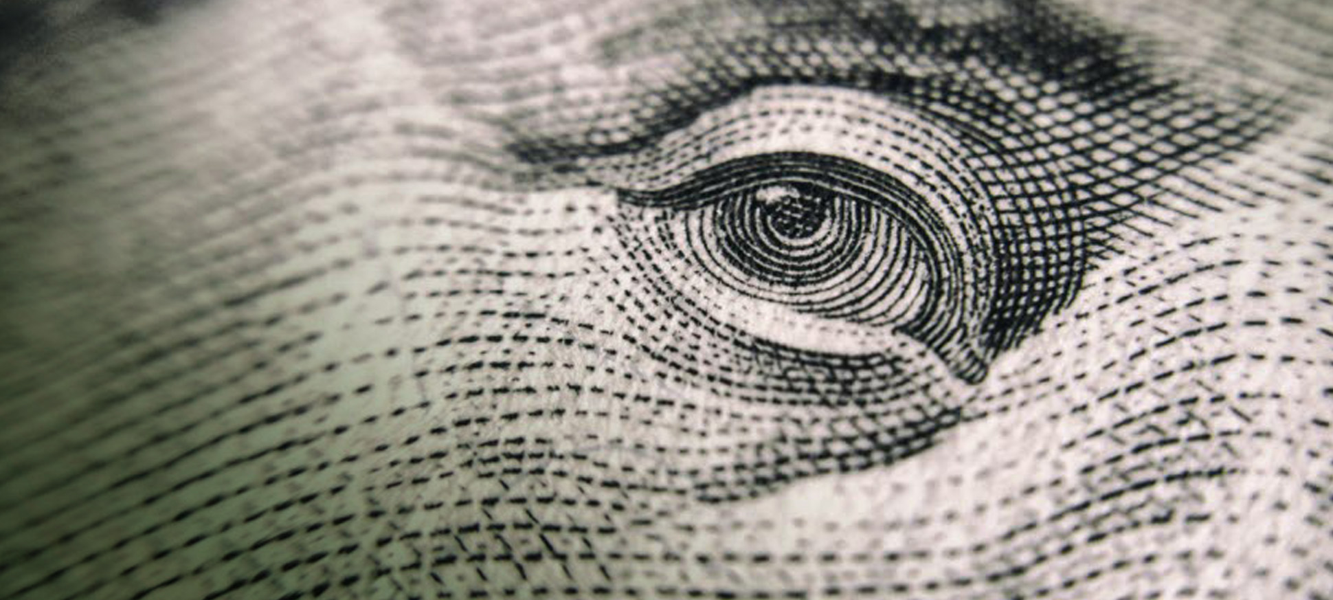 closeup of an eye on the dollar bill