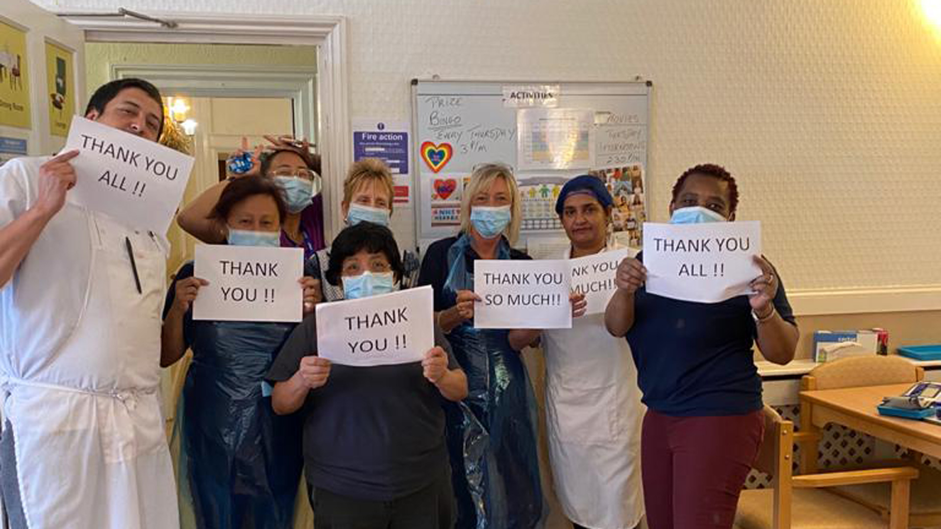 Support workers during Covid 19 holding up thank you signs